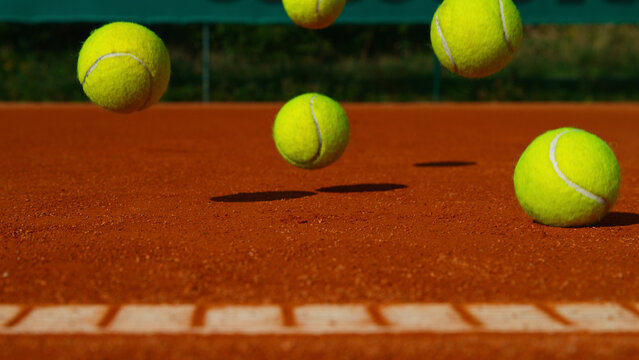 Bouncing tennis balls on clay court, freeze motion
