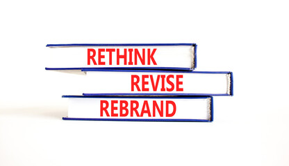 Rethink revise rebrand symbol. Concept word Rethink Revise Rebrand on beautiful books. Beautiful white table white background. Business brand motivational rethink revise rebrand concept. Copy space.