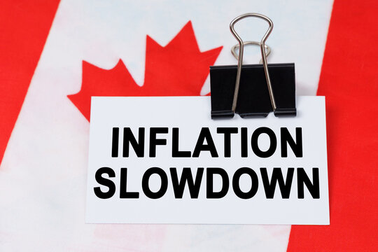 On the flag of Canada lies a business card with the inscription - inflation slowdown