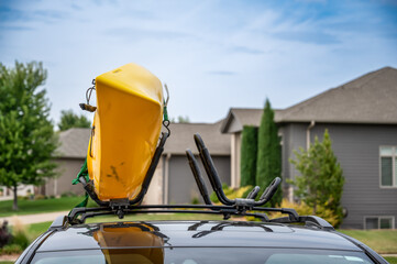 Roof mounted kayak on top of a van for transportation  - Powered by Adobe