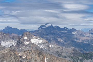 view of Gran Paradiso mountain and glacier from Ciamarella peak. cloudy sky, mountains landscape. italian Alps
