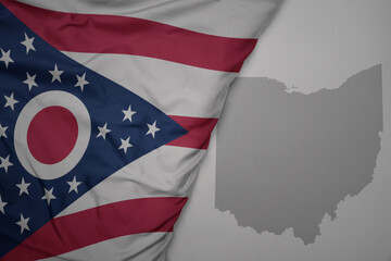 big waving national colorful flag and map of ohio state on the gray background. - obrazy, fototapety, plakaty