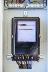 Analog electricity meter box behind glass, measures the consumption of a household, energy and...