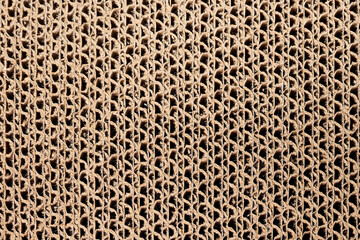 Abstract corrugated cardboard texture. Top view of brown card board made of sheets of paper. Used for strong packing material, arts, cat cardboard scratcher. Selective focus.