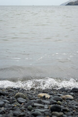 View of the shore of the turtle beach, sea waves, small waves and stones. Located in Casma, Ancash - Peru