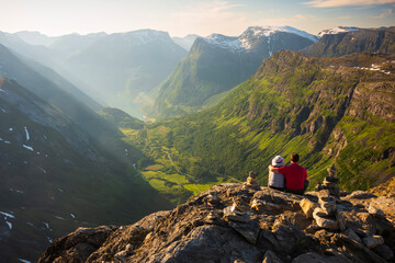  A couple takes in the view from Europe's highest fjord viewpoint by road, overlooking the town of...