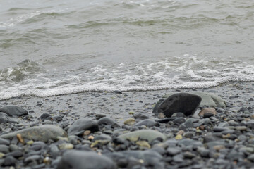 View of the shore of the turtle beach, sea waves, small waves and stones. Located in Casma, Ancash - Peru