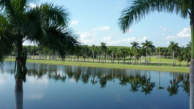 Drone shot of South Florida with lakes and palm trees, clouds with blue skies