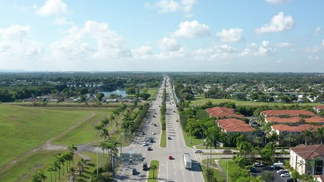 Drone shot of South Florida with lakes and palm trees, clouds with blue skies