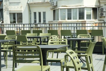 Observation area cafe. Tables and chairs on terrace against beautiful cityscape