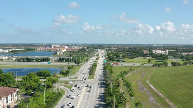 Drone shot of South Florida with lakes and palm trees, clouds with blue skies