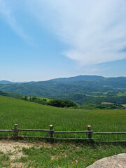 Fototapeta premium It is a ranch landscape with distant mountains and a fence.
