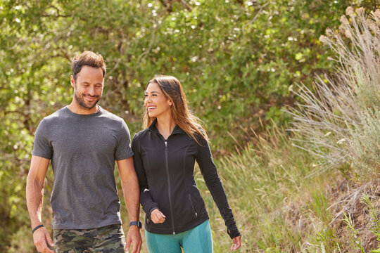 Mid adult couple hiking in forest