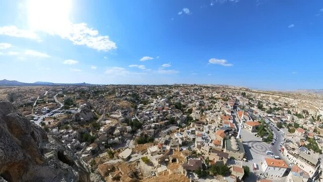 The architecture of Ortahisar Castle in Turkey is characterized by its stone walls and towers, which blend harmoniously with the natural rock formations of the area.