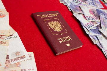 Biometric passport on red textile background. 5000 rubles. 100 GEL. Paper banknotes of Russia and Georgia. Russian ruble and Georgian lari. Concept of travel, immigration, tourism, currency exchange