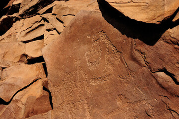 Closeup shot of layered red sandstone with ancient drawings by artists.