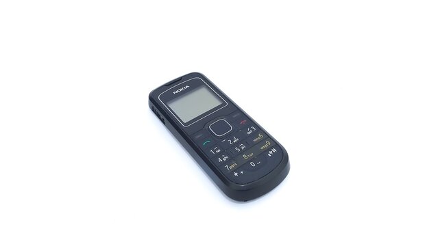 Jakarta, Indonesia - January 21, 2023: Close up of old Nokia cell phone isolated on white background. Nokia 1202 series.