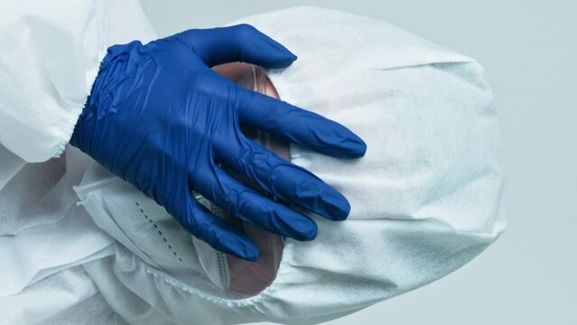 Vertical video. Medical fail. Frustrated scientist. Hospital stress. Doctor woman in white ppe coverall blue gloves with facepalm hand gesture isolated on grey background.
