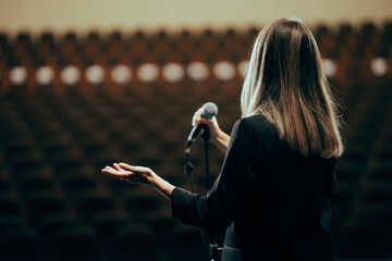 Motivational Speaker Rehearsing Presentation in Empty Theater Room. Spokesperson practicing alone before giving a public presentation

 - obrazy, fototapety, plakaty