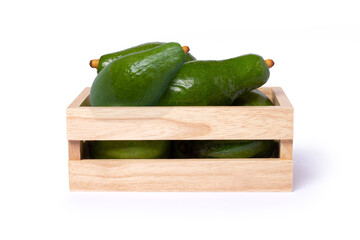 Avocado in wooden box isolated on white