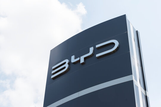 Pole billboard with logo BYD on blue sky background