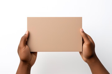 A human hand holding a blank sheet of beige paper or card isolated on a white background