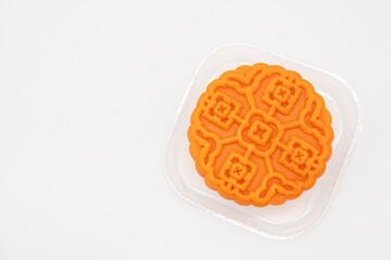 Moon cake in clear plastic tray on isolated background. Traditional Chinese mid autumn festival mooncake.