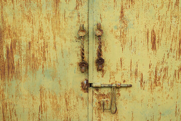 building exteriors. yellow metal door with classic door handle