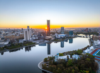 Yekaterinburg city and pond aerial panoramic view at summer or early autumn sunset. Night city in...