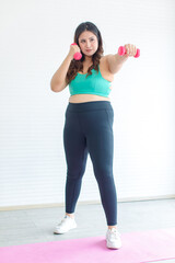 Asian young chubby fat healthy oversized overweight fit female sportswoman in casual sportswear and...
