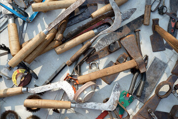 scrap metal flea market, a collection of weapons, swords, knives and axes for sale