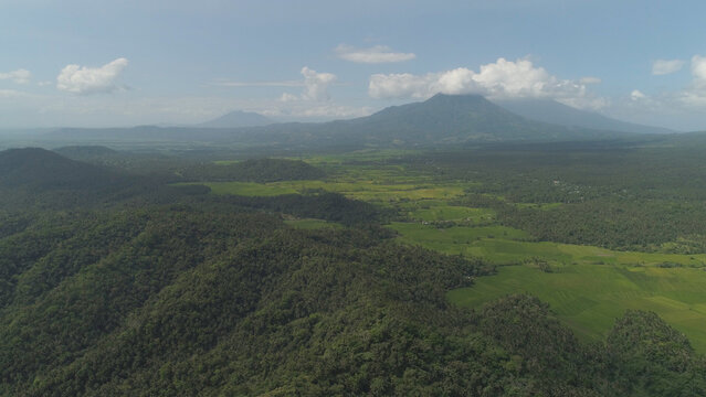 Aerial view of mountain valley with hills covered forest, trees, mount Iriga. Luzon, Philippines. Slopes of mountains with evergreen vegetation. Mountainous tropical landscape.