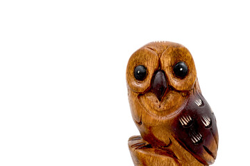 Wooden owl (Strigiformes) carved from wood, handcrafted. copy space. isolated on white. Front view.