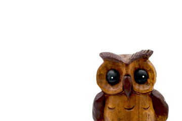 Wooden owl (Strigiformes) carved from wood, handcrafted. copy space. isolated on white. Front view.