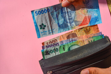 The financial concept of the Indonesian currency, namely the rupiah, is being issued with a black wallet