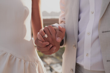 Couple holding hands closeup, engagement photoshoot