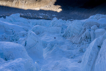 Climbers walking on Khumbu icefall on the way to the top of Mount Everest 