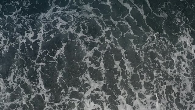 Overhead Shot of Ocean Waves with Patterns and Textured Background in the Shallow Waters of Looc Bay, Philippines.