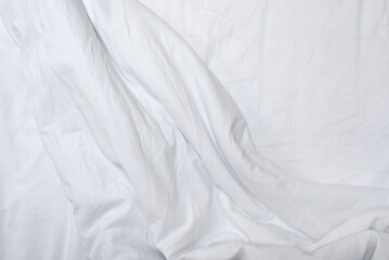 Messy white cotton bedding. Crumpled blanket and sheet, lifestyle neutral bedroom background....