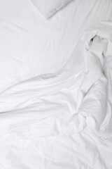 Aesthetic neutral white crumpled cotton textile background. Messy bedding, blanket and sheet