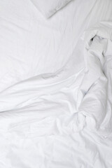 Obraz premium Aesthetic neutral white crumpled cotton textile background. Messy bedding, blanket and sheet