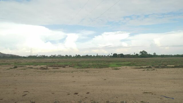 Panoramic view of sacred Falgu River dry waterbed with a long stretch of sand dunes under clear sky, Bodhgaya, Bihar, India