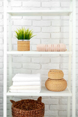 Bathroom shelf with towels and baskets in the house