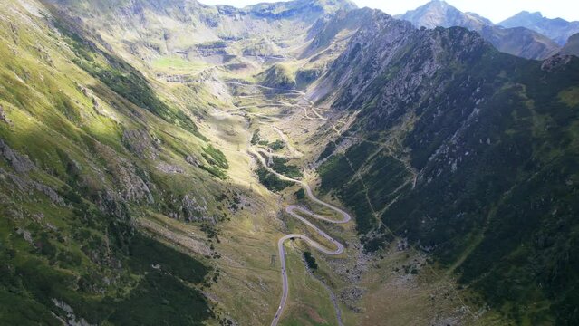 Panoramic high angle aerial overview tilt down above Transfagarasan Serpentine Road