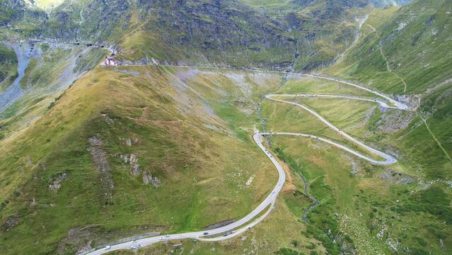 Aerial trucking pan of Transfagarasan Serpentine Road overview of extreme landscape