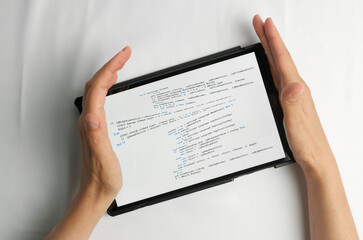 Programming and coding concept. Program code creation: hands inserting a new piece of code into the...