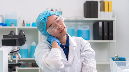 Scientist working laboratory neck pain stretching and office syndrome tired