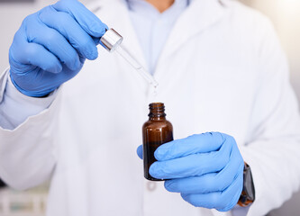 Scientist, hands and pipette with oil for experiment, dosage or measurement in laboratory. Closeup...