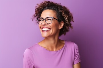 Portrait of a beautiful young african american woman with curly hair and glasses smiling against purple background - obrazy, fototapety, plakaty