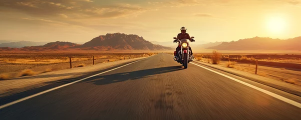Poster Driver riding motocycle on empty road in sunset light.  Panorama photo. © Michal